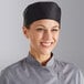 A woman wearing a black Choice cloth chef's hat.