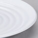 A close up of a white GET Milano melamine plate with a wavy pattern.