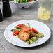 A Milano white melamine plate with chicken and asparagus on it.