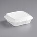 A Dart white foam take out container with a hinged lid.