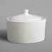 A RAK Porcelain ivory porcelain sugar bowl lid on a white ceramic container.