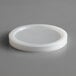 A white plastic lid on a white surface.