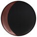 A black and brown RAK Porcelain deep plate with a bronze moon shape on a black surface.