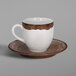 A white and brown RAK Porcelain espresso cup and saucer.