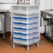 A blue plastic Vollrath vinyl cover over a full size glass rack.