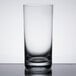 A close-up of a clear Stolzle New York highball glass on a table.