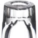 A close up of a Libbey fluted shot glass with a black rim.
