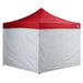 A red and white tent with a white mesh.