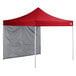 A red tent with a triangular top and white canopy walls.
