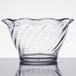A clear glass tulip dessert dish with a wavy design.