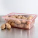 A red Cambro polycarbonate food storage box with potatoes inside.