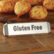 An American Metalcraft stainless steel tabletop sign with "Vegan / Vegetarian / Gluten-Free" text on a wooden surface next to food.