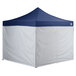 A blue tent with white fabric walls and a white triangular top.