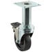 A black and metal swivel plate caster with brake.
