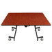 A National Public Seating square cafeteria table with a wood surface and T-mold edge.