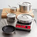 Vigor stainless steel cookware set with pots and pans on a counter.