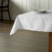 A white tablecloth with a plate on it.