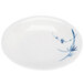 A white plate with blue and white bamboo designs on the rim.