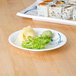 A Thunder Group Blue Bamboo melamine plate with a sushi roll and a salad on it.