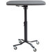 A black National Public Seating Cafe Time II square table with wheels.