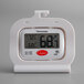 A white digital thermometer with a screen.