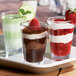 A group of Carlisle Alibi dessert shot glasses filled with three different desserts.