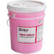 A pink bucket of Noble Chemical concentrated fabric softener with a white lid.