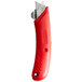 A close up of a Pacific Handy Cutter red left-hand safety cutter with a red handle.
