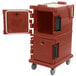 A brick red plastic Cambro Ultra Camcart food pan carrier with a door open.