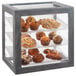 An Ashwood gray oak Cal-Mil bakery display case with pastries on trays inside.