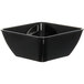 A black Dinex square bowl with a lid on a counter.