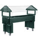 A forest green Carlisle portable salad bar on a table with a clear cover.