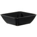 A black square Dinex bowl on a counter.