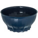 A dark blue Dinex convection bowl with wavy edges and a black rim.