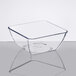 A clear square Dinex SAN plastic bowl on a table.