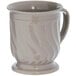 A white Dinex latte mug with a handle and a wavy design on the base.