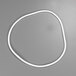 A white gasket with a wire on a gray surface.