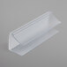 A clear plastic Snap Drape table skirt clip with a white hook.