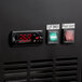 The black panel of an Avantco UDD-2-HC beer dispenser with a digital clock and temperature control with red numbers.