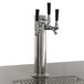 An Avantco UDD-2-HC beer dispenser with silver metal taps and black handles on a counter.