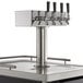 An Avantco black beer dispenser with a metal base and four stainless steel taps.