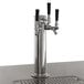 An Avantco beer dispenser with three silver metal taps and black handles on a counter.