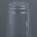 A Dart Clear plastic cup on a gray surface.