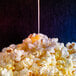 A pile of popcorn with Superb Select Liquid Butter Alternative poured on top.