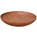 A round faux wood polystyrene bowl on a table.