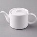 A white Arcoroc teapot with a lid.