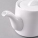 A white Arcoroc stackable teapot with a lid.