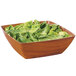 A square faux wood bowl filled with lettuce on a white background.
