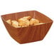 A square faux wood bowl filled with bread crumbs.