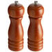 Two wooden Acopa salt and pepper mills with metal handles.